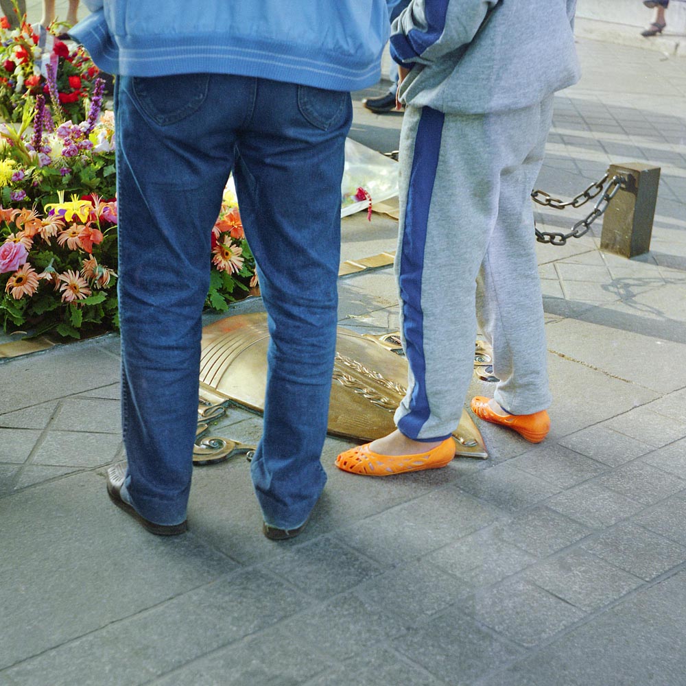 legs people pedestrians memorials shoes Paris tomb orange blew gray grey stripe pants feet legs surrealism