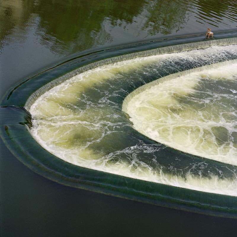 bath water chair blue green cascade dam reflections fountain waterfall white steps person flow rapid circle arch ridge surrealism